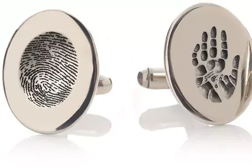 Memorial keepsake cufflinks displaying engraved fingerprint, handprint and footprint details.