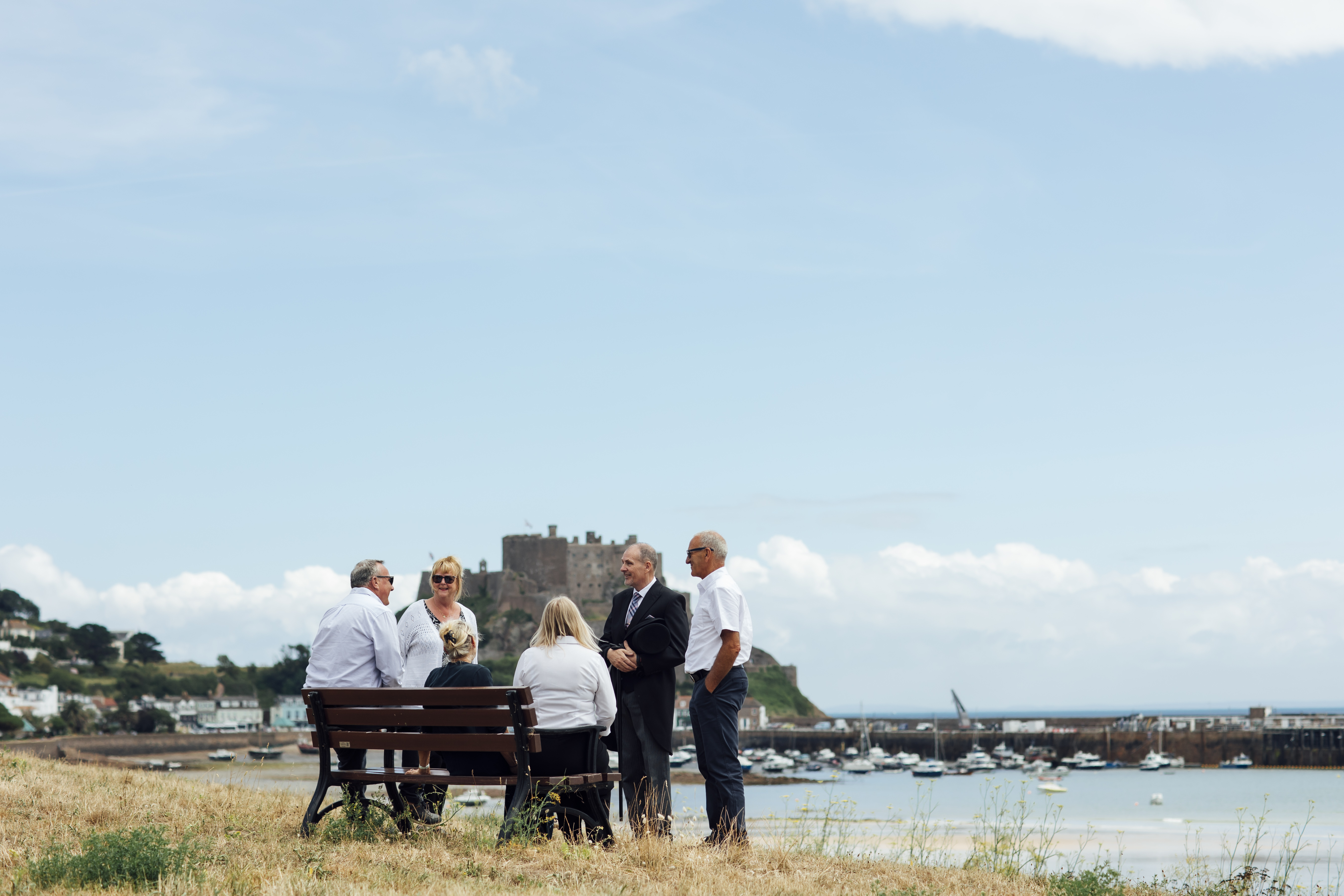 A funeral director chats warmly with a group of people.