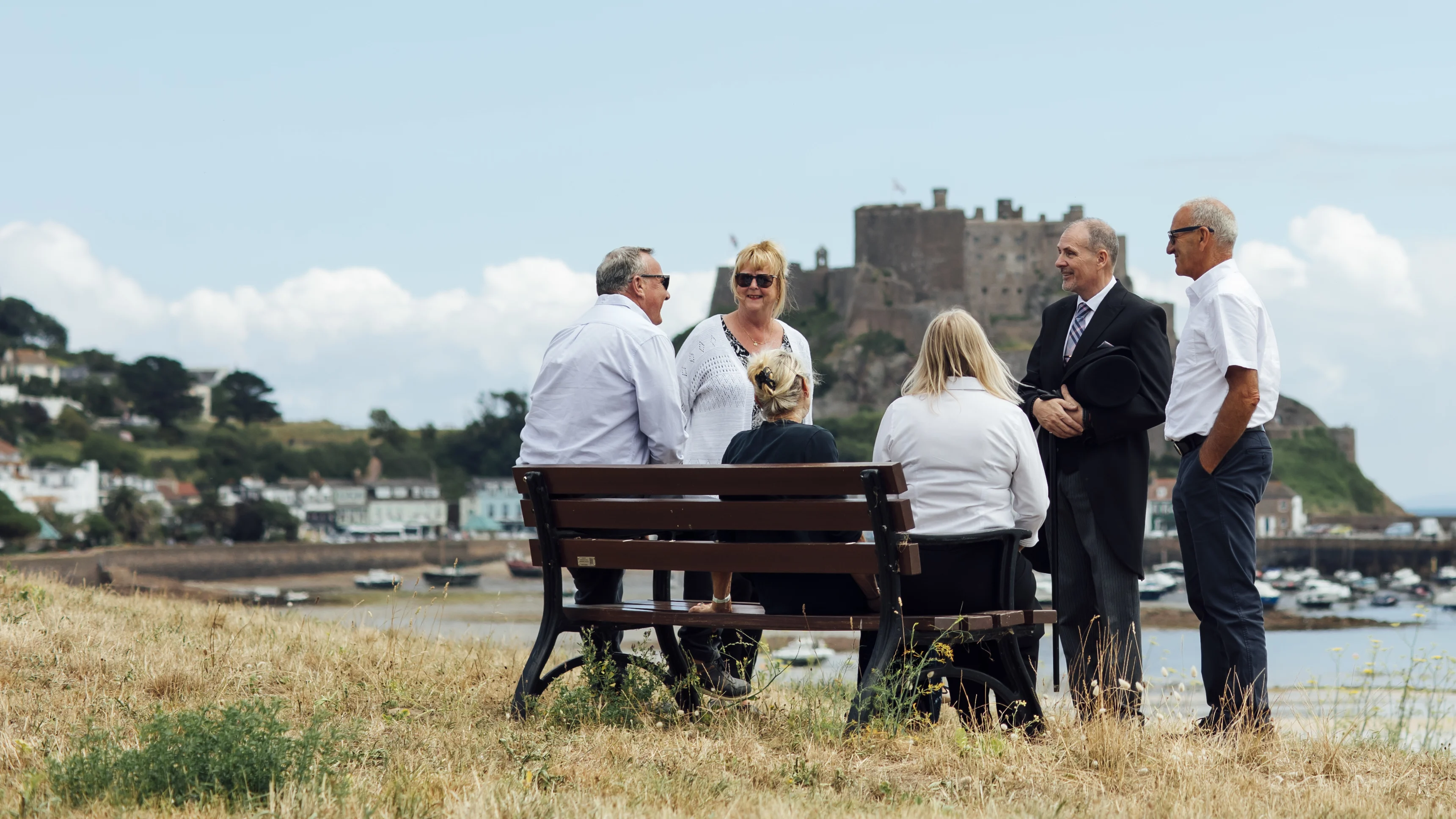 A funeral director chats warmly with a group of people.