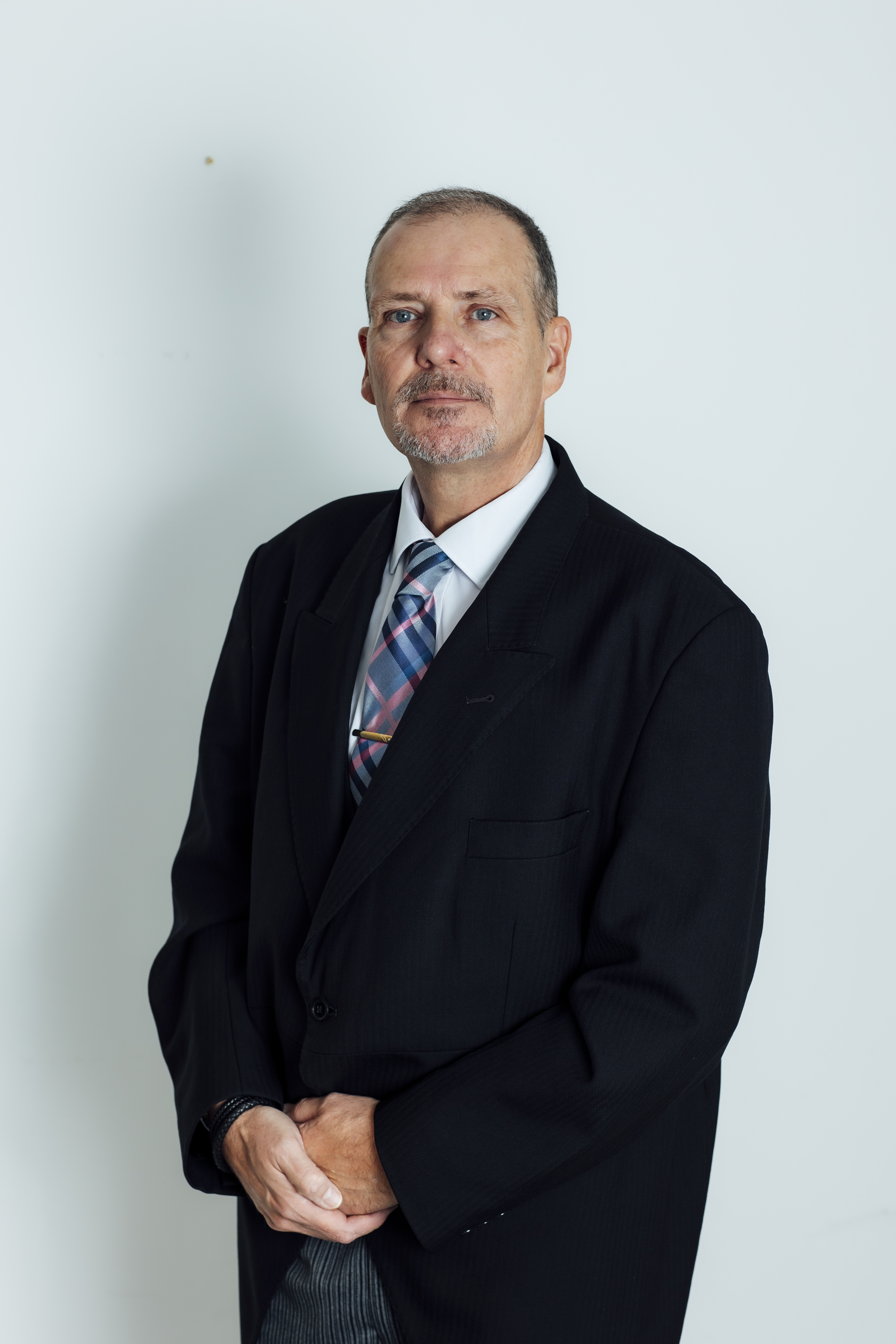 Funeral director from Coop Funeral Care by De Gruchy dressed in traditional formal funeral wear posing for a professional portrait.
