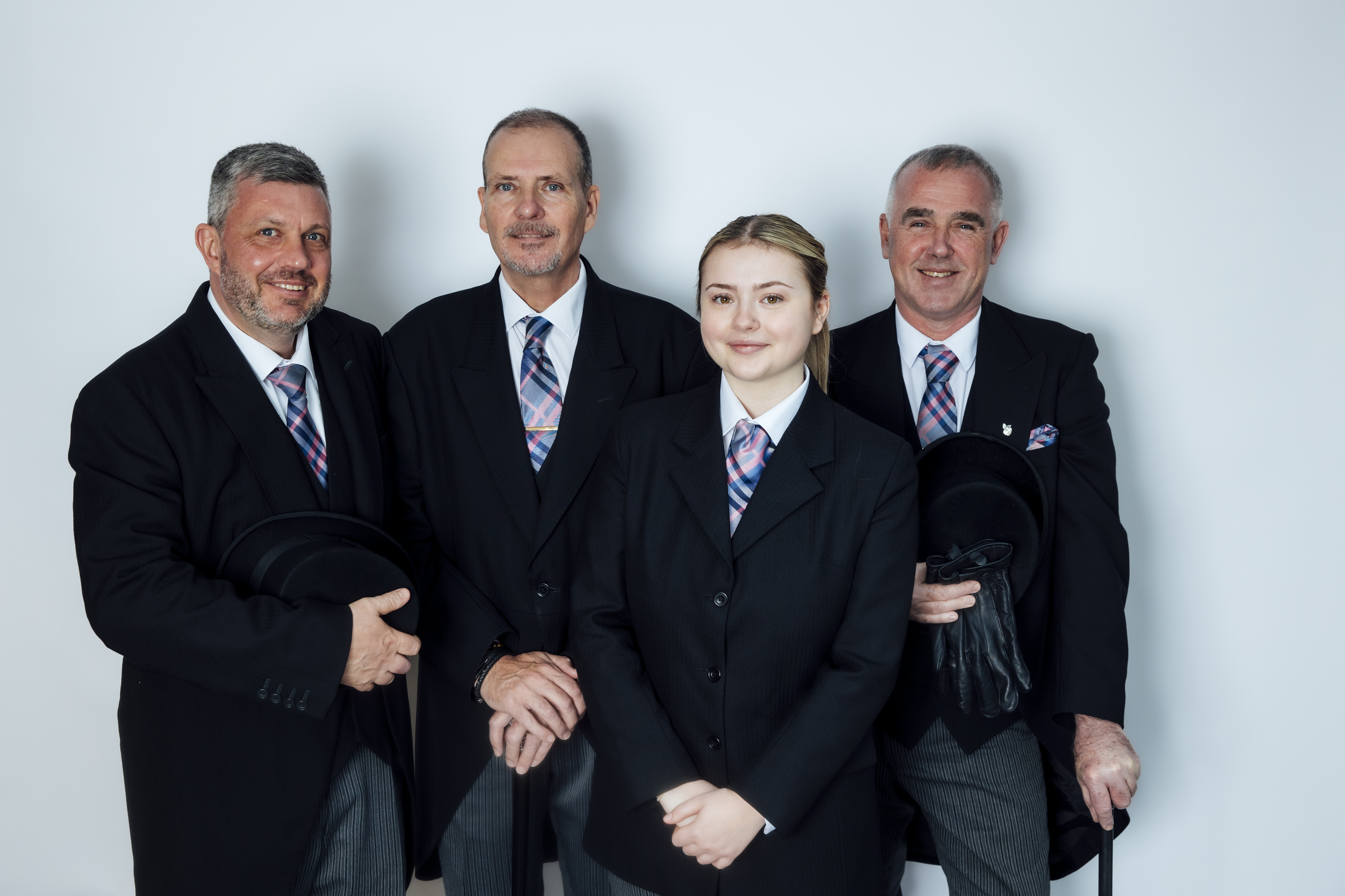 Team of funeral directors from Coop Funeral Care by De Gruchy in traditional formal attire, providing compassionate support for families arranging a funeral.